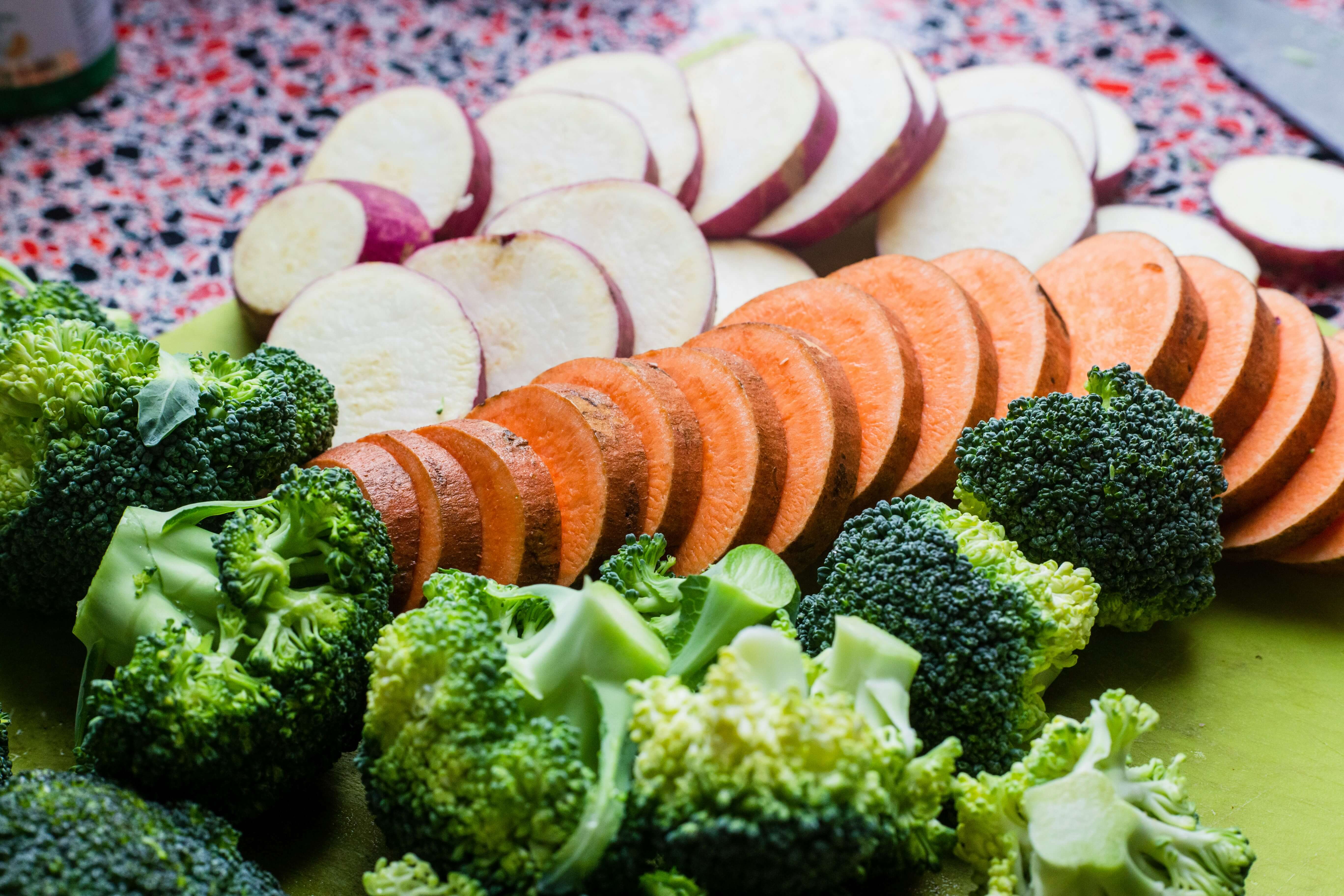 Sliced sweet potatoes arranged on a rustic kitchen board